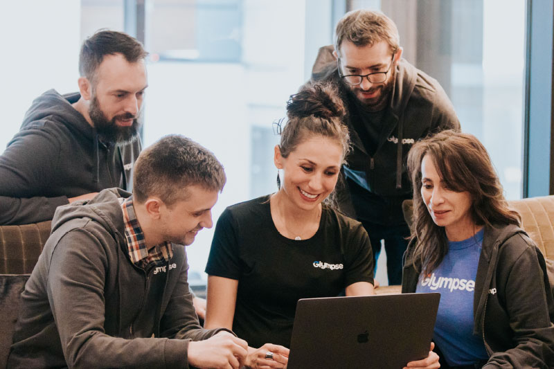 Glympse team member huddled around a laptop